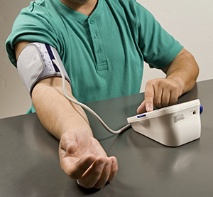 Man taking his blood pressure at home.